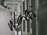 a black and white photo of a man holding a skateboard