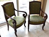 two chairs sitting next to each other in front of a window