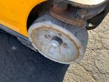 a close up of a wheel on a yellow vehicle