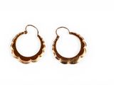 a pair of gold hoop earrings on a white background