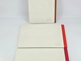 a white and red book sitting on top of a white table