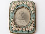 a picture of a baby in a picture frame on the wall