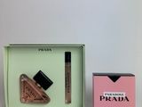 a box with a bottle of liquid and a lipstick in it