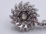 a close up of a brooch with a crystal in it
