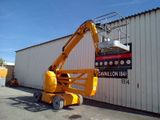 a yellow scissor that is parked in front of a building