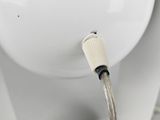 a close up of a white toilet with a hose attached to it