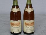 two bottles of wine that are sitting on a table