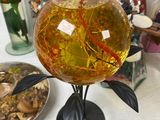 a vase with a fish inside of it on a table