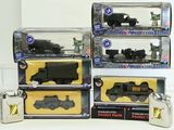 four different toy trains in boxes on a table