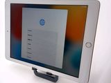 tablet computer sitting on top of a white table with a screen on it