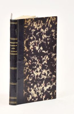 a black and gold book on a white surface