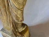 a statue of a woman holding a vase on a table