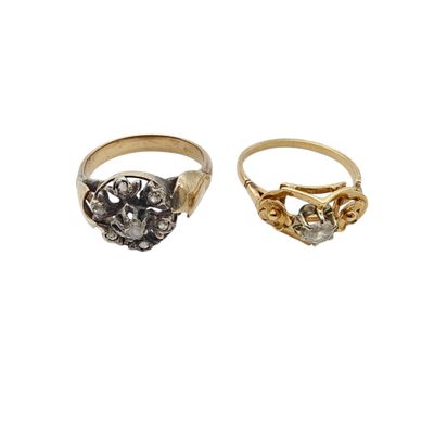 two gold and silver rings, one with a stone and the other with a diamond