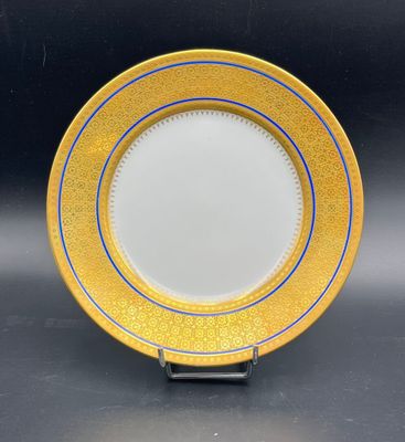 a close up of a yellow and blue plate on a black surface