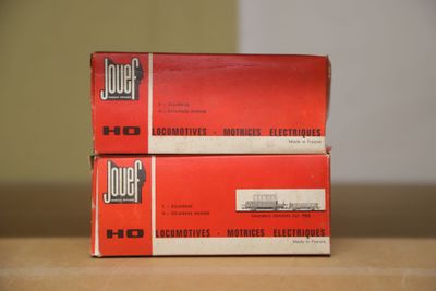 two boxes of jouet cigarettes sitting on top of a wooden table