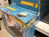 two boxes of tvs stacked on top of each other in a store