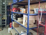 a blue shelf with boxes on it in a garage