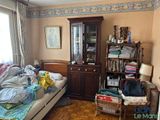 a bed in a room with a book shelf and a book case