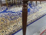 a table with a chair and a rug on the floor