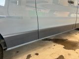 a car that has been painted silver and is parked in a garage
