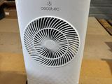 a white air cooler sitting on top of a wooden table
