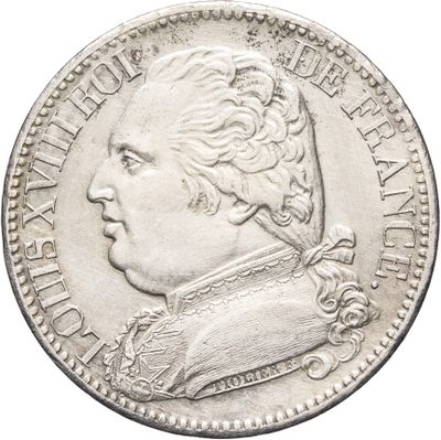 Gros plan sur une pièce de monnaie portant le visage d'un homme