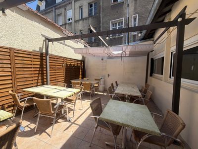 tables and chairs on the patio of a building