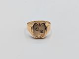 an image of a gold signet ring with the letter g on it