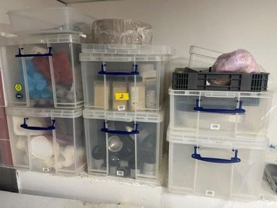 many plastic containers that are stacked on top of each other