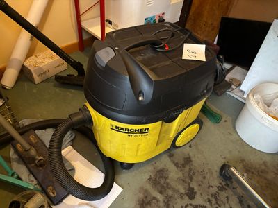 a yellow and black vacuum sitting on the floor in a room