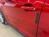 a close up of a car door handle with a sticker on it