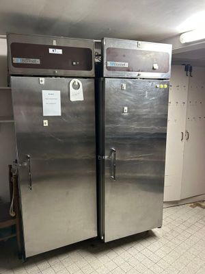 two stainless steel refrigerators in a kitchen next to each other