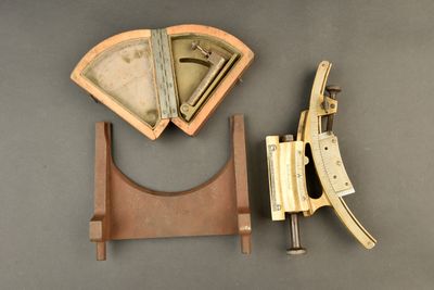 a wooden stand with a pair of scissors next to it