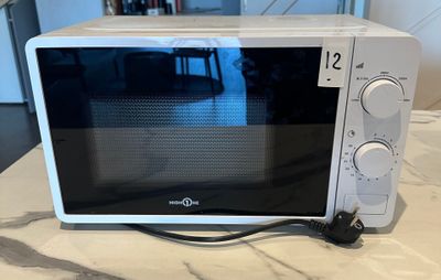 a microwave that is sitting on a counter top