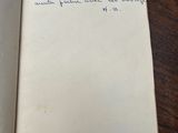 an open book with writing on it on a wooden table