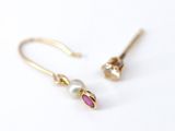 a pair of gold earrings with a pearl and a pink stone