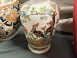 two vases that are sitting on a table