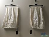 two pairs of pants hanging on the wall next to each other