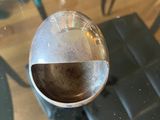 a glass table with a metal ball on top of it