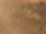 a silver plate with writing on it sitting on a table