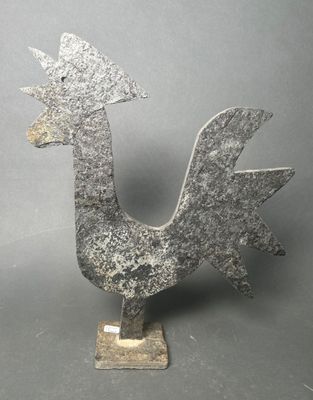 an image of a metal sculpture of a rooster on a stand
