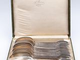 an assortment of silverware in a case on a white background