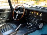 a dashboard and steering wheel of a classic car