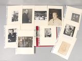 a lot of old black and white photos on a table