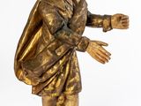 bronze statue of a man with a bag on his back