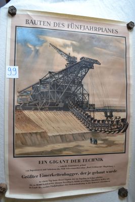 a poster on the wall of a building that has a crane on it