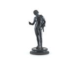 figurine of a man holding a gun on a white background