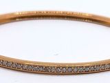 a close up of a gold bracelet with diamonds on it