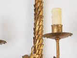 two candles that are on the wall next to each other