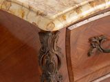 a marble top on the top of a wooden dresser